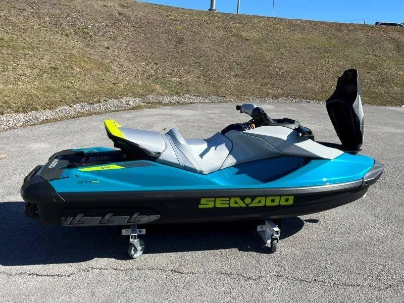 Slide: The Image of 2024 Sea-Doo GTI SE 130 IBR jet ski in blue, parked on pavement. - 22