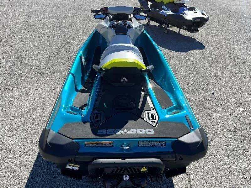 Slide: The Image of 2024 Sea-Doo GTI SE 130 IBR jet ski, blue and white, rear view on pavement. - 28