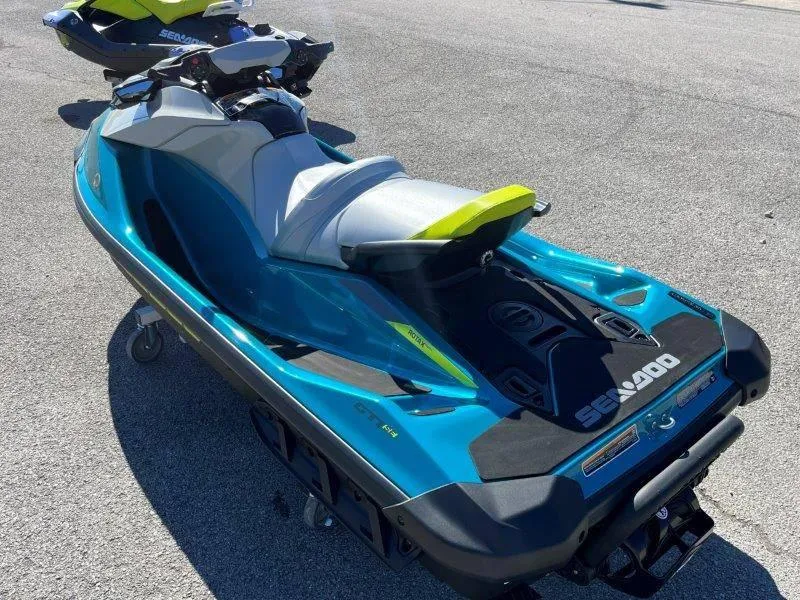 Slide: The Image of 2024 Sea-Doo GTI SE 130 IBR jet ski in vibrant blue on pavement. - 29