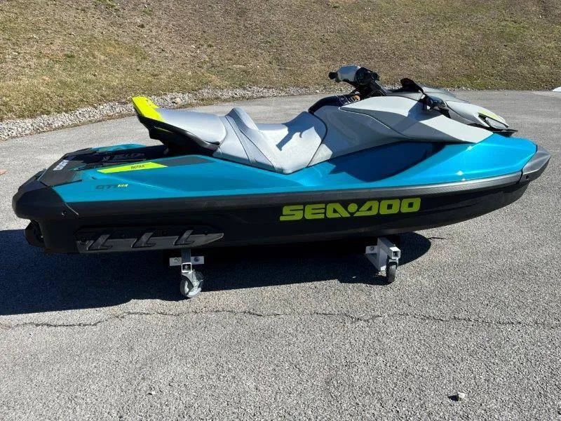 Slide: The Image of 2024 Sea-Doo GTI SE 130 IBR jet ski in vibrant blue on pavement. - 32