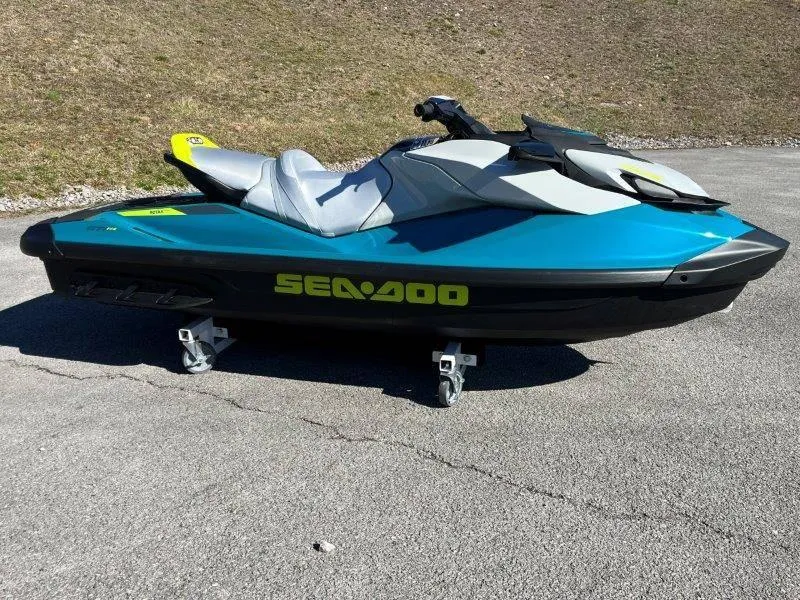 Slide: The Image of 2024 Sea-Doo GTI SE 130 IBR jet ski in vibrant blue on pavement. - 33