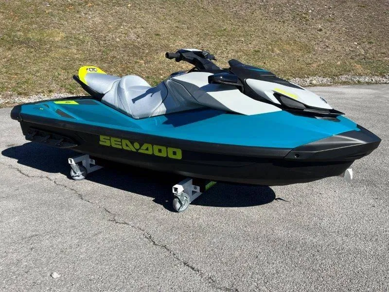 Slide: The Image of 2024 Sea-Doo GTI SE 130 IBR jet ski on pavement, vibrant blue and black design. - 9