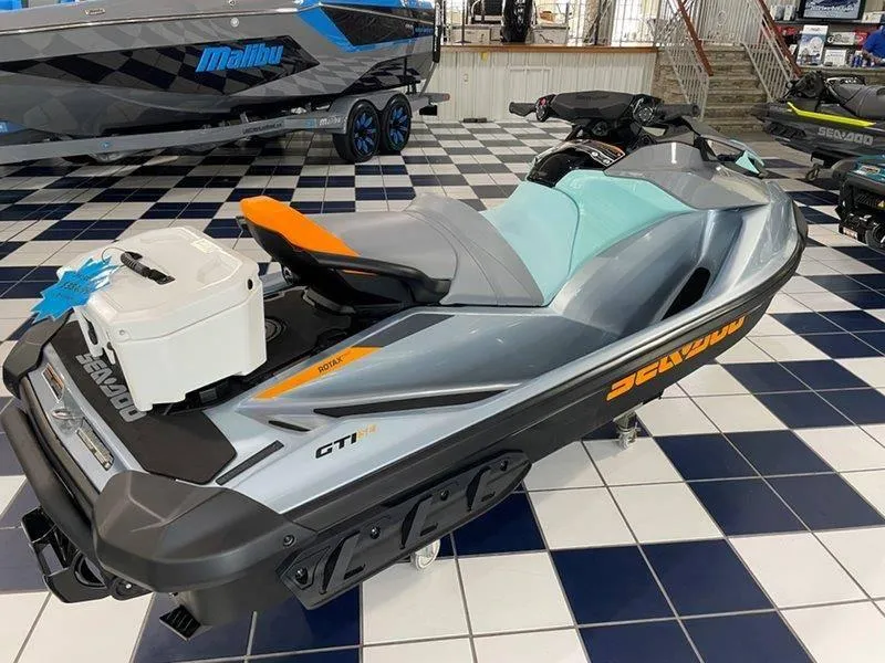 Slide: The Image of 2024 Sea-Doo GTI SE 130 IBR jet ski displayed in showroom. - 14