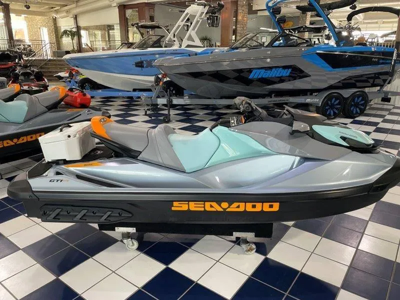 Slide: The Image of 2024 Sea-Doo GTI SE 130 IBR jet ski displayed in showroom. - 22