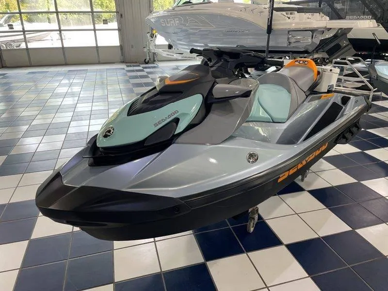 Slide: The Image of 2024 Sea-Doo GTI SE 130 IBR jet ski in showroom, sleek design, modern features. - 3