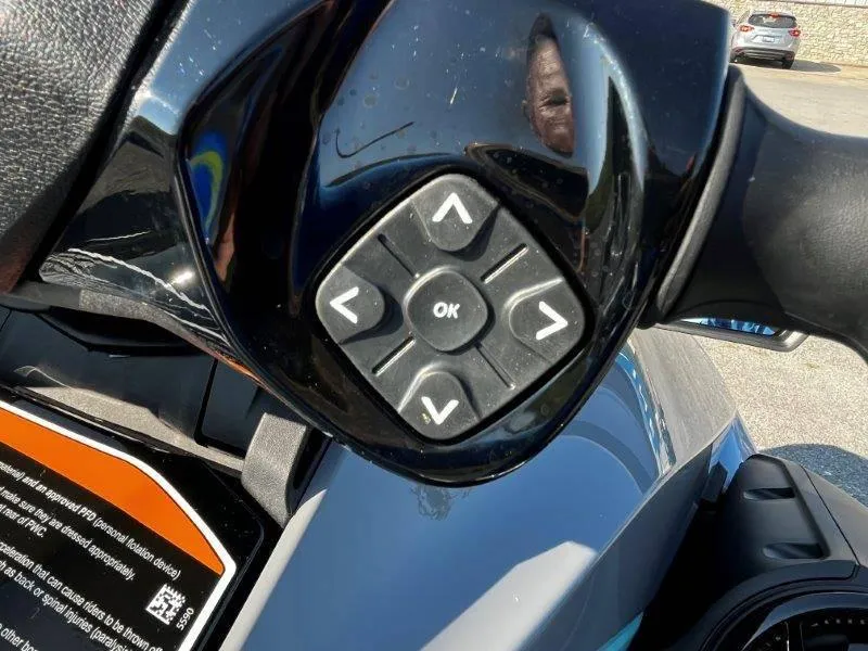 Slide: The Image of Close-up of 2024 Sea-Doo GTI SE 130 iBR control panel with directional buttons. - 12