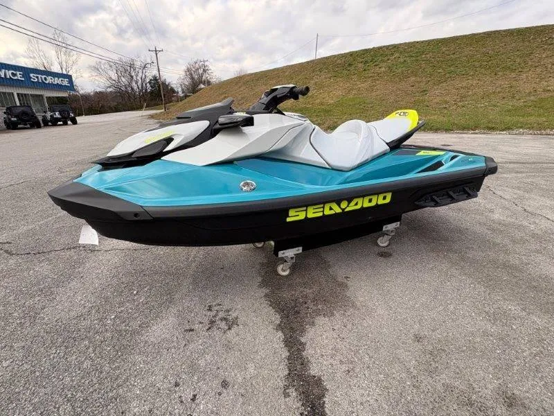 Slide: The Image of 2024 Sea-Doo GTI SE 170 IBR jet ski in blue and white on pavement. - 15