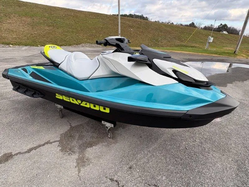 Slide: The Image of 2024 Sea-Doo GTI SE 170 IBR jet ski in vibrant blue and white on pavement. - 23