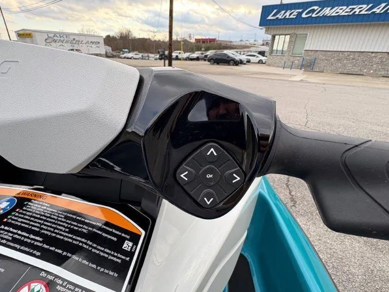 Slide: The Image of 2024 Sea-Doo GTI SE 170 IBR handlebar controls with directional buttons. - 5