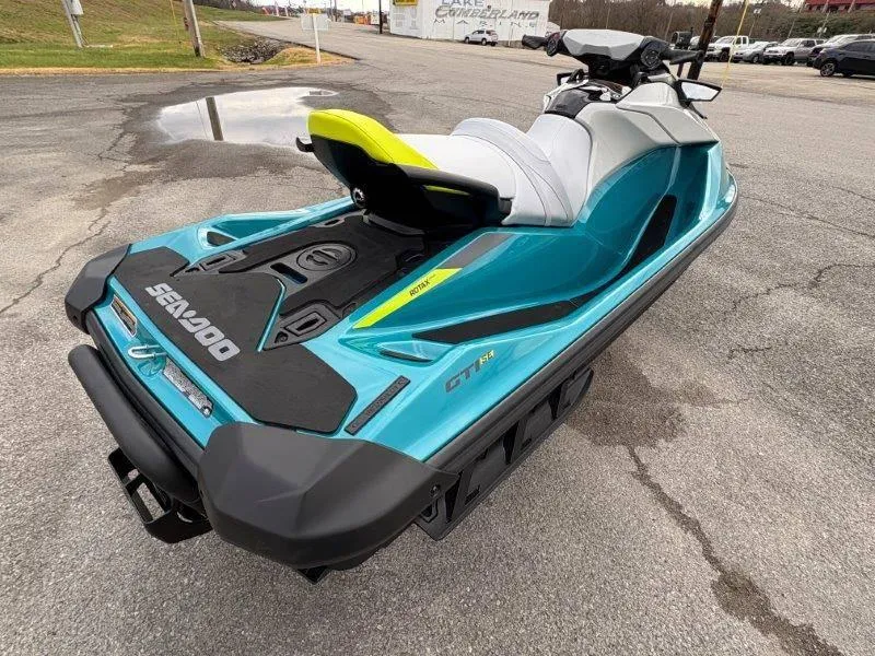 Slide: The Image of 2024 Sea-Doo GTI SE 170 IBR jet ski in vibrant teal, parked on pavement. - 7