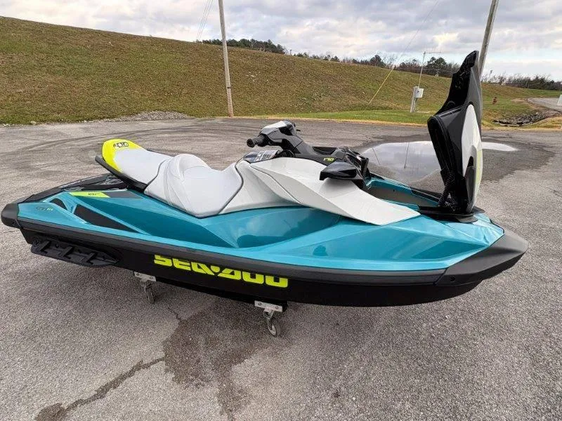 Slide: The Image of 2024 Sea-Doo GTI SE 170 IBR jet ski in vibrant blue on pavement. - 8