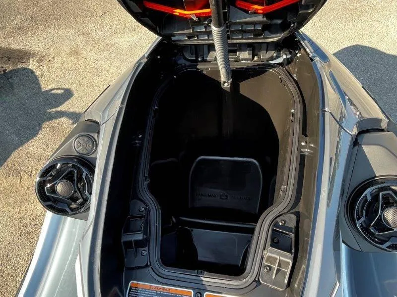 Slide: The Image of 2024 Sea-Doo RXT-X 325 storage compartment open, showcasing interior space. - 11