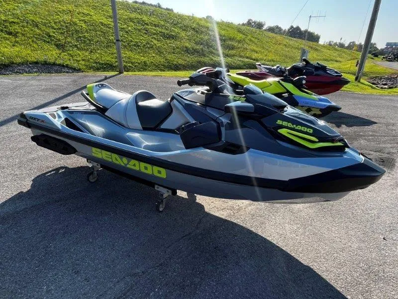 Slide: The Image of 2024 Sea-Doo RXT-X 325 in Ice Metal and Manta Green on display outdoors. - 17