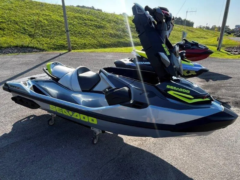 Slide: The Image of 2024 Sea-Doo RXT-X 325 in Ice Metal and Manta Green on display outdoors. - 27