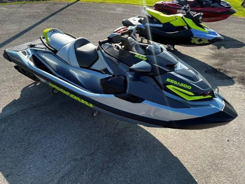 Slide: The Image of 2024 Sea-Doo RXT-X 325 in Ice Metal and Manta Green on pavement. - 31