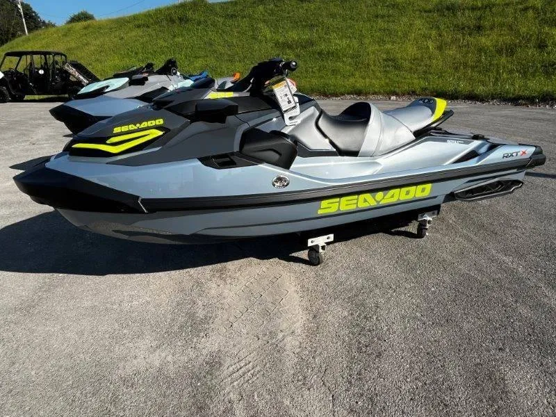 Slide: The Image of 2024 Sea-Doo RXT-X 325 in Ice Metal/Manta Green on pavement. - 8