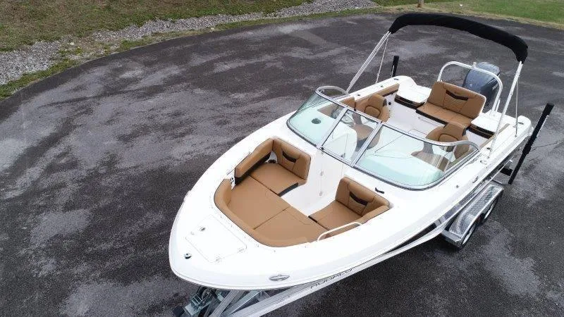 Slide: The Image of 2024 Robalo R207 boat with tan seating on a trailer. - 11
