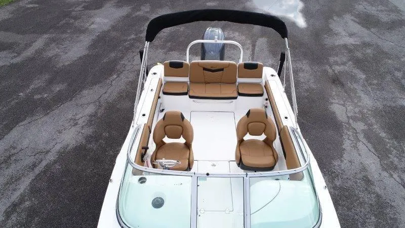 Slide: The Image of 2024 Robalo R207 boat interior with tan seating and black canopy. - 13