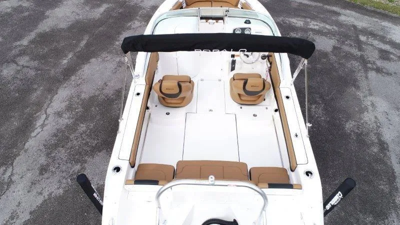 Slide: The Image of 2024 Robalo R207 boat interior with tan seating and black canopy. - 14