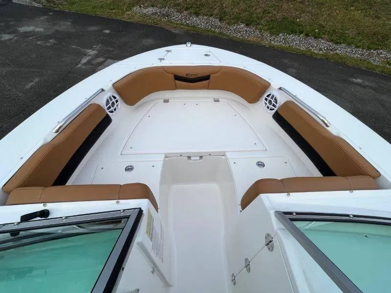 Slide: The Image of 2024 Robalo R207 boat interior with tan seating and white deck. - 19