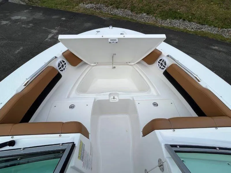 Slide: The Image of 2024 Robalo R207 boat interior with open storage compartment and cushioned seating. - 20