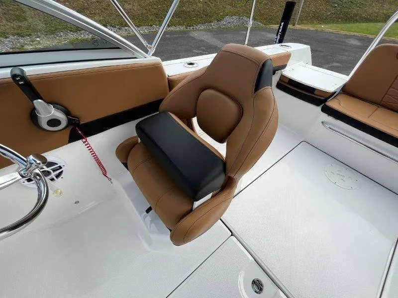 Slide: The Image of 2024 Robalo R207 boat interior with tan leather seating and modern design. - 26