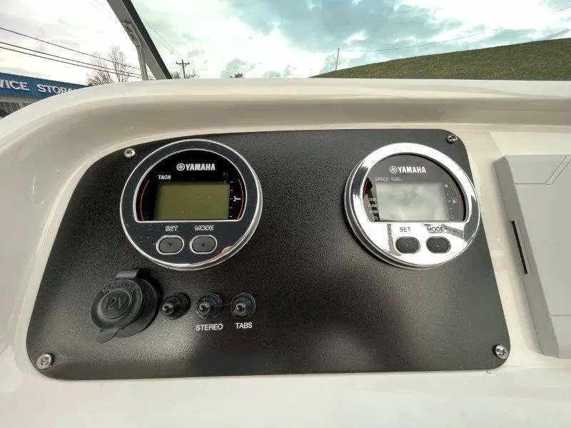 Slide: The Image of Yamaha gauges on 2024 Robalo R207 boat dashboard, featuring tachometer and speed fuel indicators. - 29