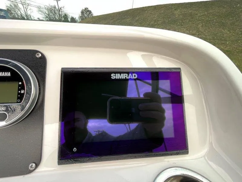 Slide: The Image of Simrad display on 2024 Robalo R207 boat dashboard with Yamaha controls. - 32