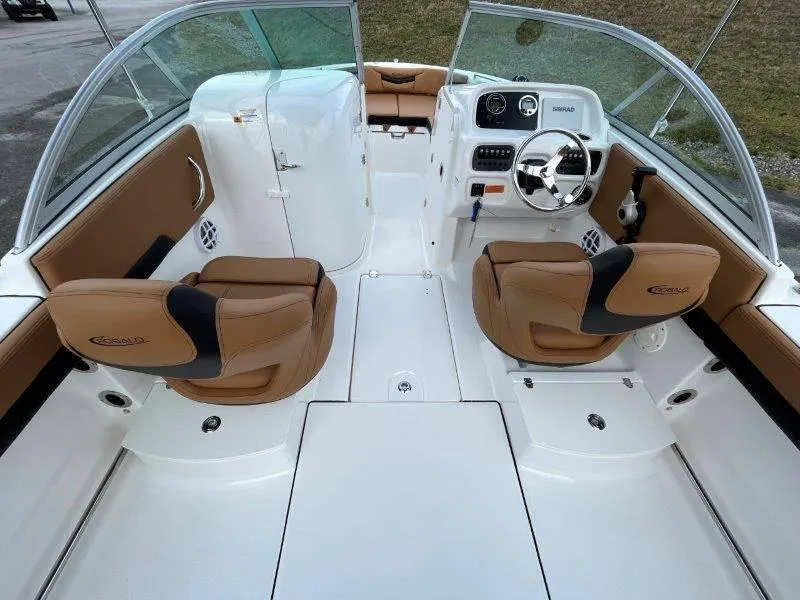 Slide: The Image of 2024 Robalo R207 boat interior with tan seats and modern dashboard. - 33