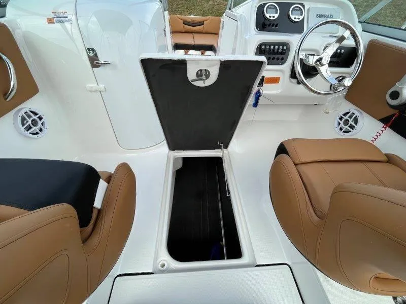 Slide: The Image of 2024 Robalo R207 boat interior with open storage compartment and tan seating. - 34
