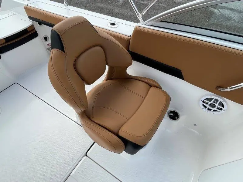 Slide: The Image of 2024 Robalo R207 boat interior with tan leather seat and white deck. - 36