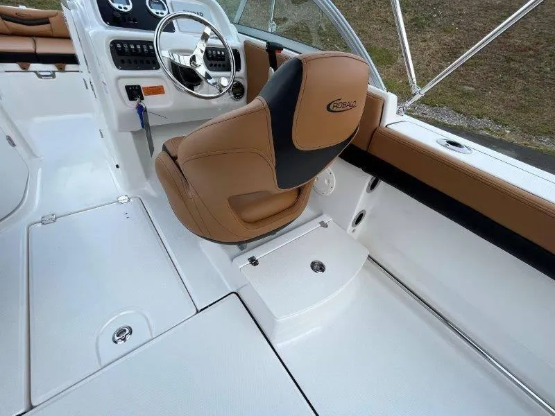 Slide: The Image of 2024 Robalo R207 boat interior with tan seating and modern dashboard. - 38