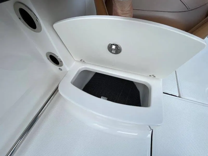 Slide: The Image of Open storage compartment on 2024 Robalo R207 boat deck. - 40