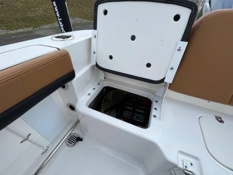 Slide: The Image of 2024 Robalo R207 boat storage compartment with open lid, showcasing interior details. - 46