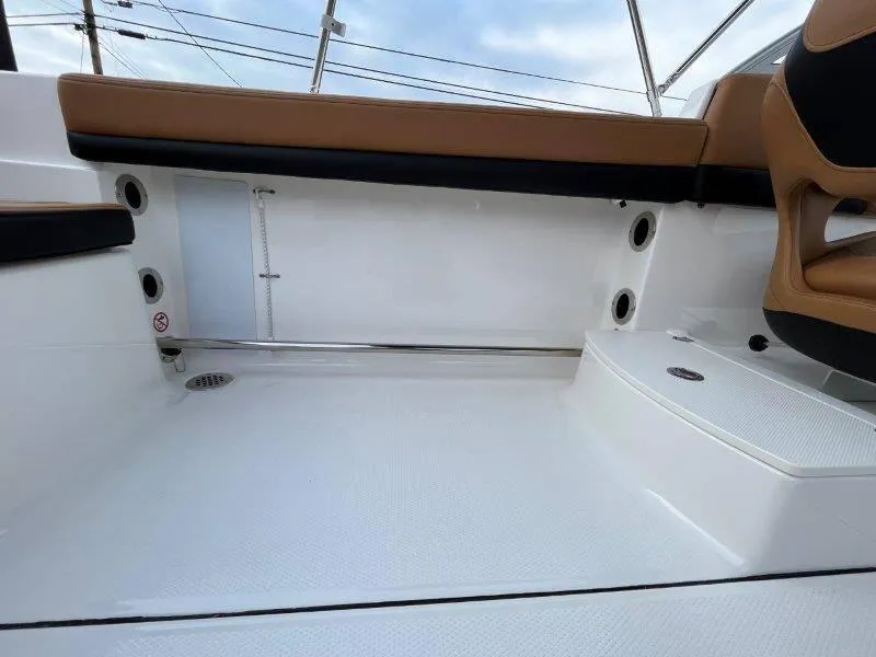 Slide: The Image of 2024 Robalo R207 boat interior with tan seating and white flooring. - 48