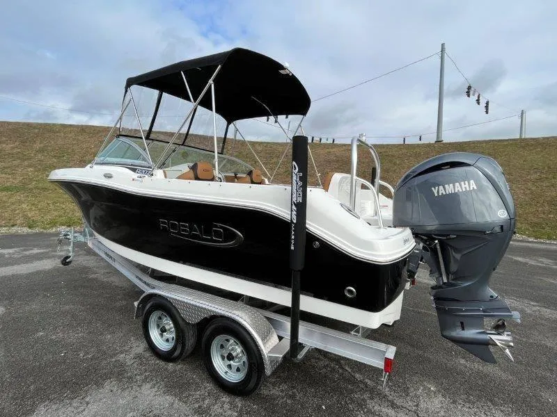 Slide: The Image of 2024 Robalo R207 boat with Yamaha engine on trailer, black and white design. - 49