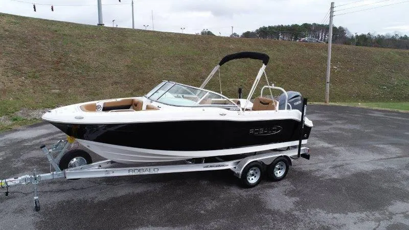 Slide: The Image of 2024 Robalo R207 boat on trailer, black and white design, parked outdoors. - 6