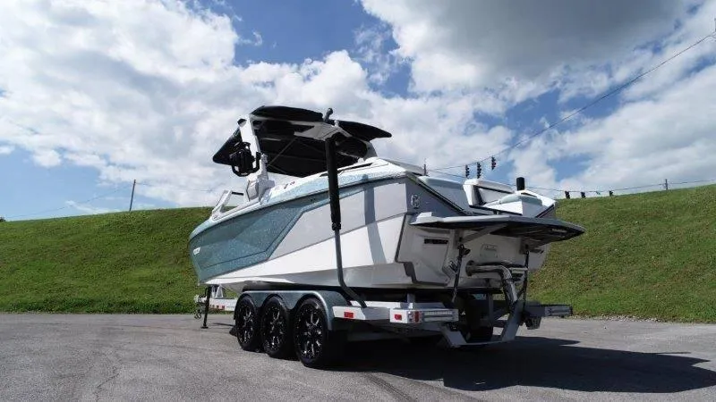 Slide: The Image of 2020 Nautique Paragon P25 boat on trailer under blue sky. - 11