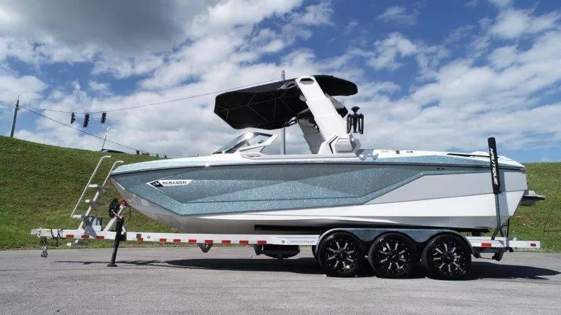 Slide: The Image of 2020 Nautique Paragon P25 boat on trailer under blue sky. - 12