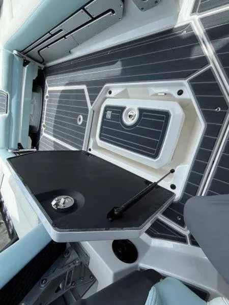 Slide: The Image of 2020 Nautique Paragon P25 boat interior with sleek, modern design and storage compartment. - 16