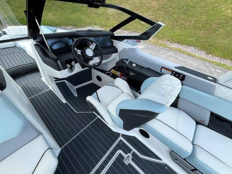 Slide: The Image of Interior of 2020 Nautique Paragon P25 boat with sleek seating and modern dashboard. - 26