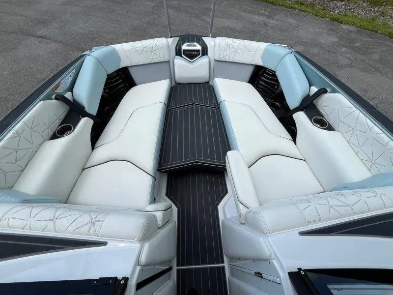 Slide: The Image of 2020 Nautique Paragon P25 boat interior with luxurious white seating and sleek design. - 27