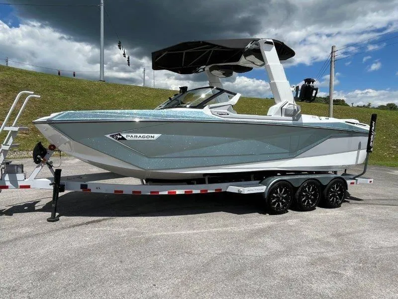 Slide: The Image of 2020 Nautique Paragon P25 boat on trailer under cloudy sky. - 3