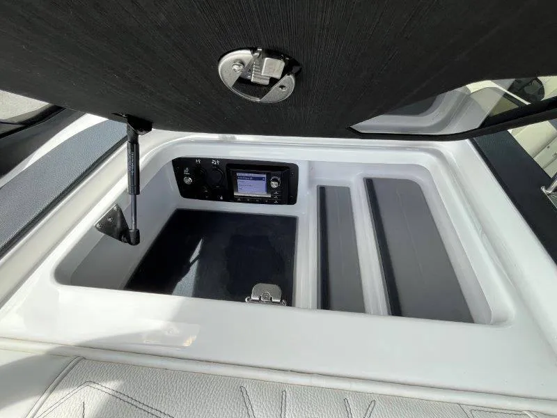 Slide: The Image of 2020 Nautique Paragon P25 storage compartment with control panel and latch. - 31
