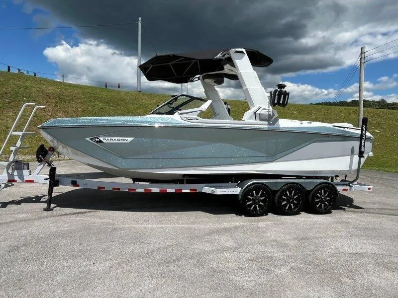 Slide: The Image of 2020 Nautique Paragon P25 boat on trailer under cloudy sky. - 4