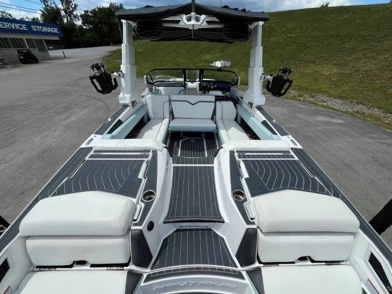 Slide: The Image of 2020 Nautique Paragon P25 boat interior with luxurious seating and sleek design. - 43