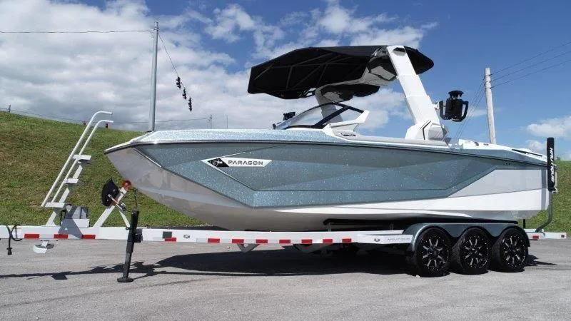 Slide: The Image of 2020 Nautique Paragon P25 boat on trailer under blue sky. - 5
