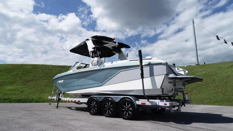 Slide: The Image of 2020 Nautique Paragon P25 boat on trailer under blue sky. - 6