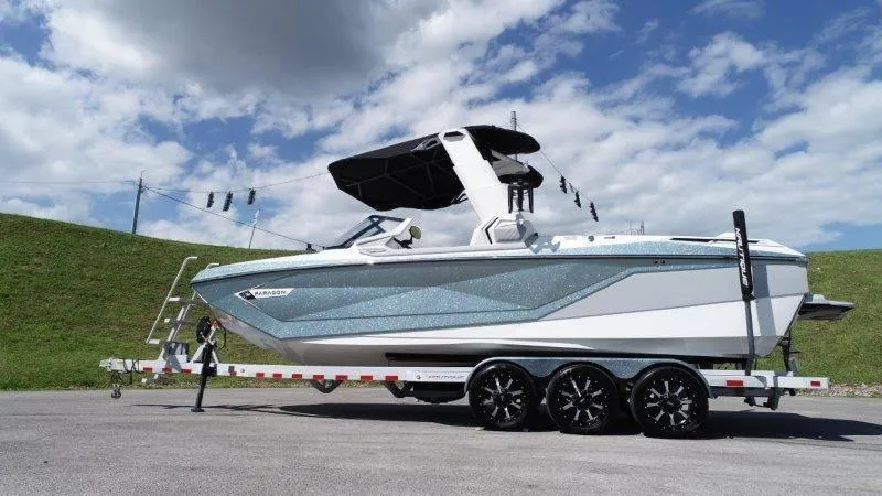 Slide: The Image of 2020 Nautique Paragon P25 boat on trailer under blue sky. - 7
