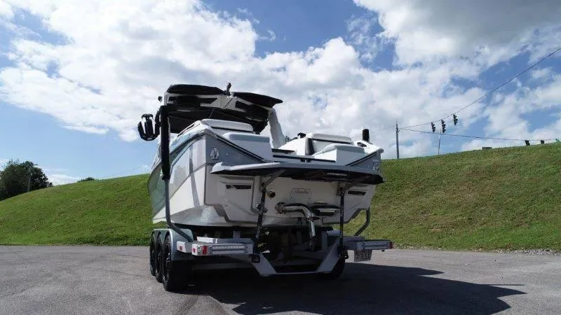 Slide: The Image of 2020 Nautique Paragon P25 boat on trailer under blue sky. - 8